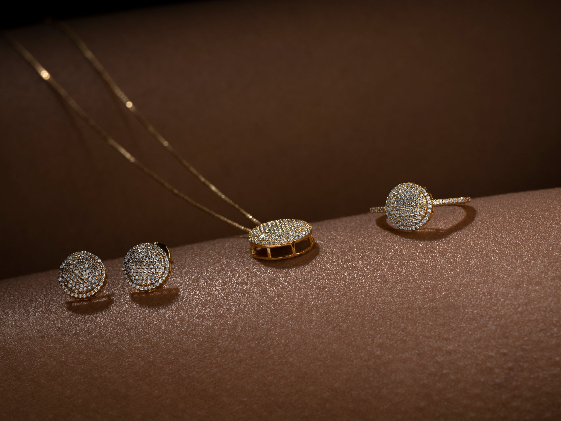 Set of diamond-encrusted jewelry on a brown surface