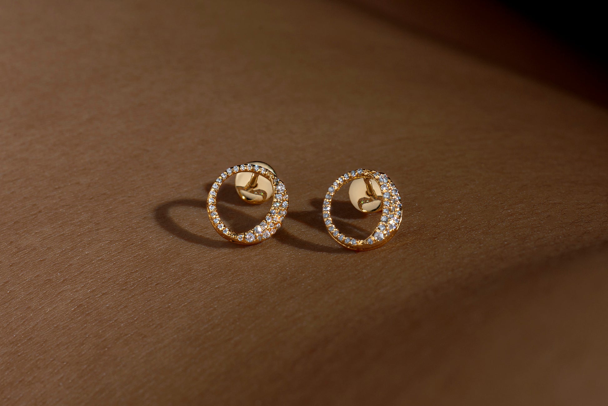 Waxing gibbous phase earring design, crafted from sterling silver with a high polish finish, featuring american diamonds