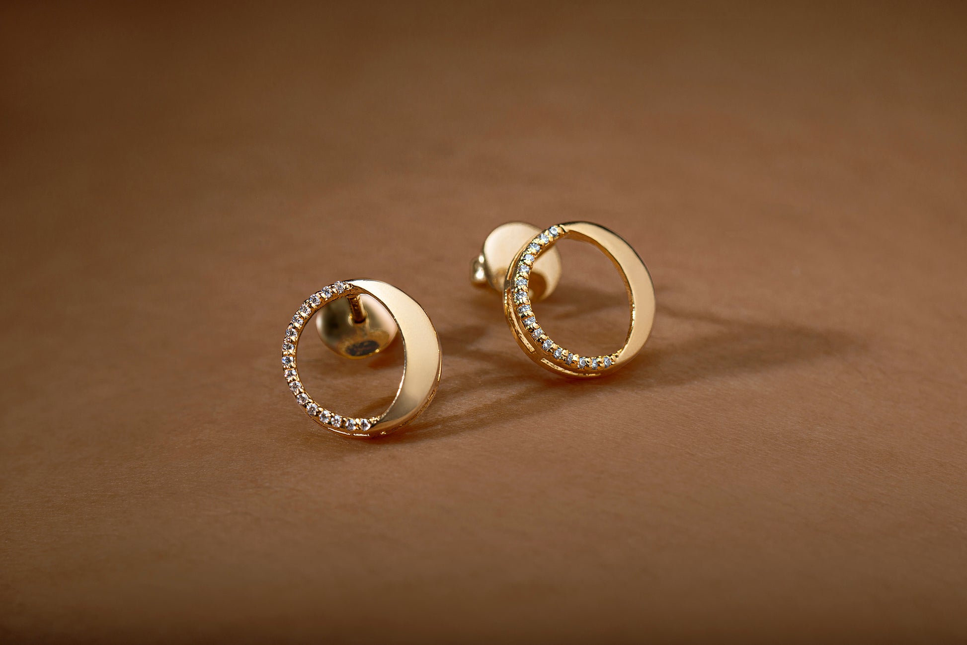 Waxing gibbous phase earring design, crafted from sterling silver with a high polish finish, featuring american diamonds
