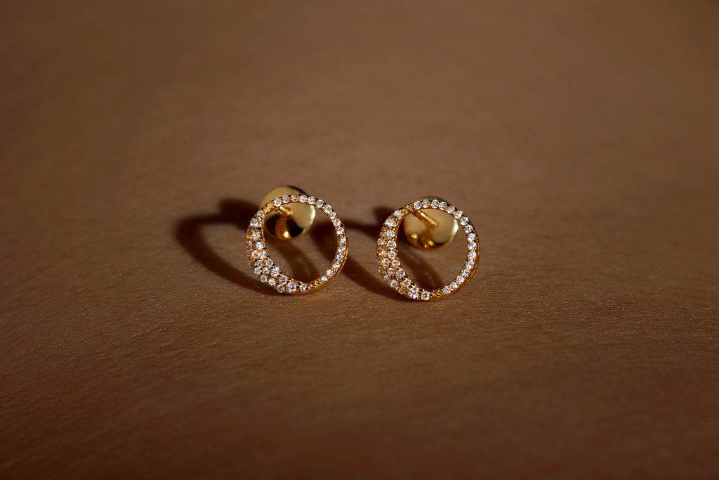 Waxing gibbous phase earring design, crafted from sterling silver with a high polish finish, featuring american diamonds