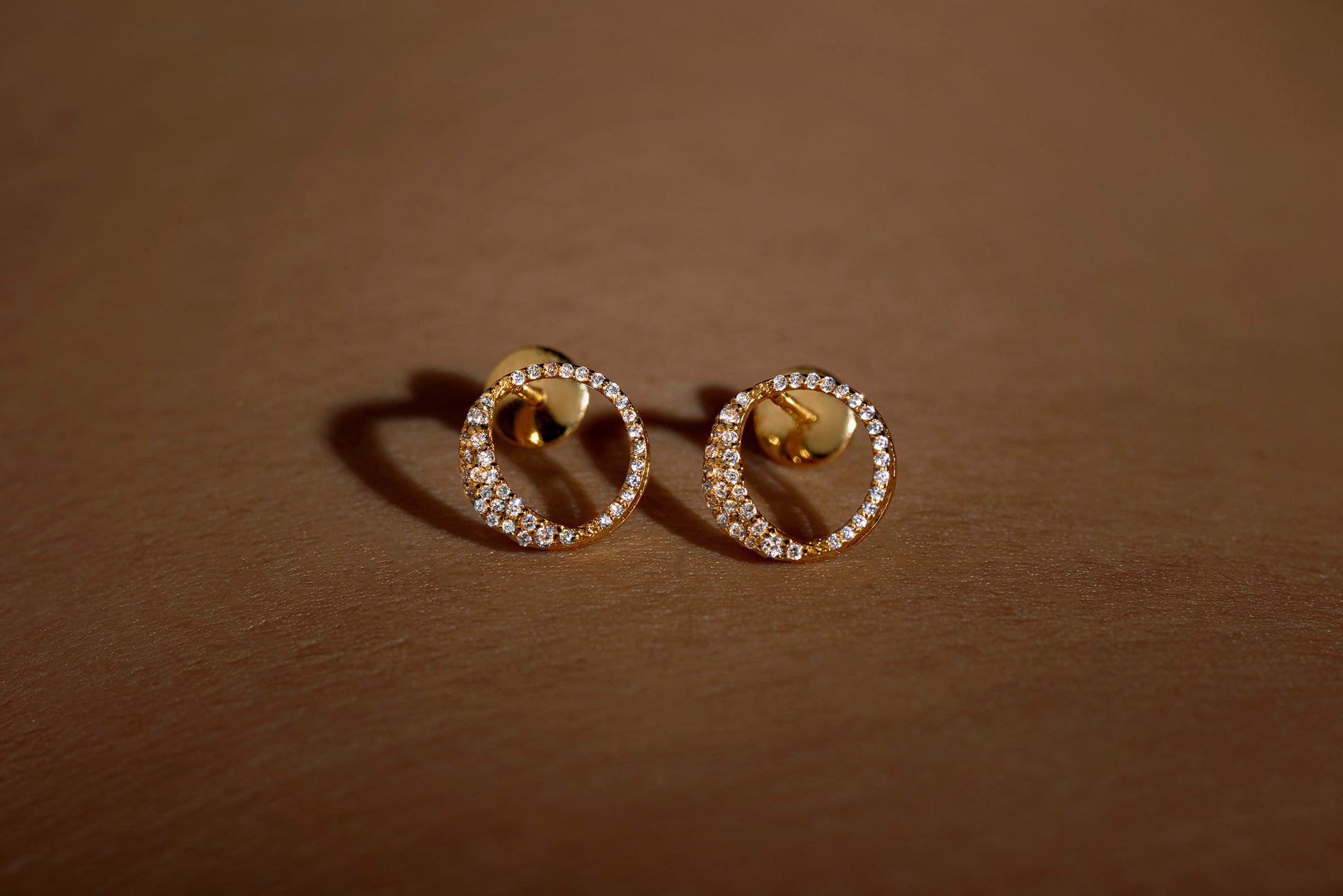 Waxing gibbous phase earring design, crafted from sterling silver with a high polish finish, featuring american diamonds