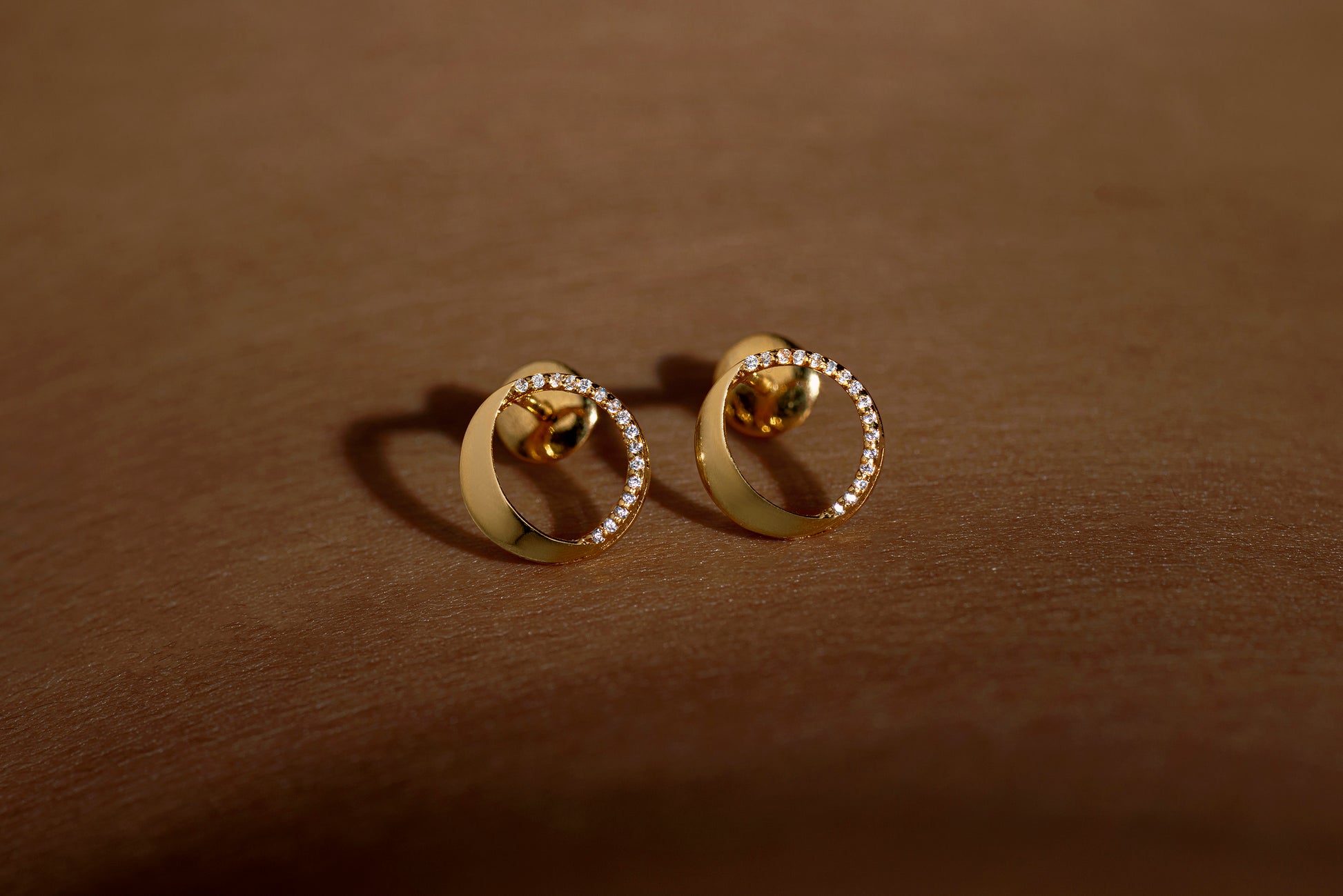 Waxing gibbous phase earring design, crafted from sterling silver with a high polish finish, featuring american diamonds